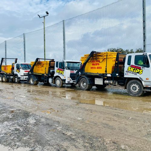 Skip bin hire Gold Coast - line of large trucks