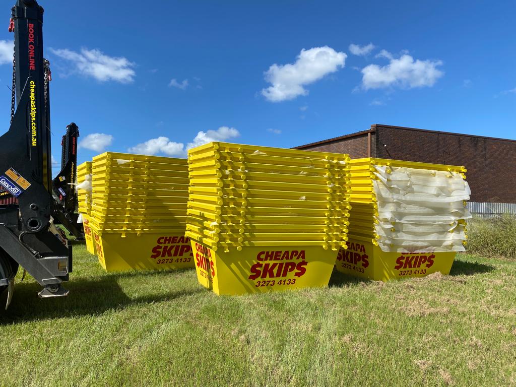 Tips To Reduce Construction & Renovation Waste - stacked yellow skips