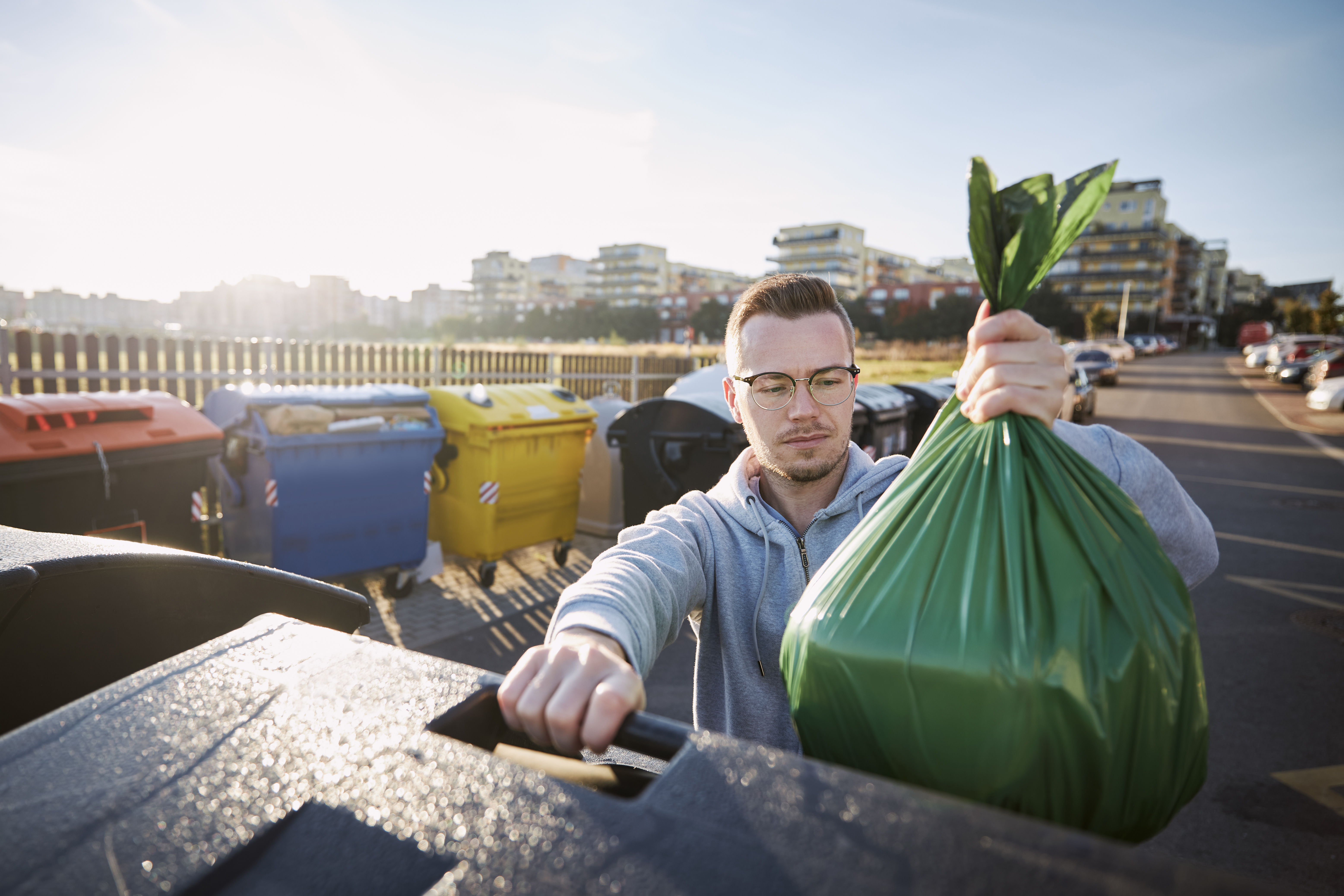 Choosing the Right Skip Bin Provider - Man throwing rubbish to garbage can