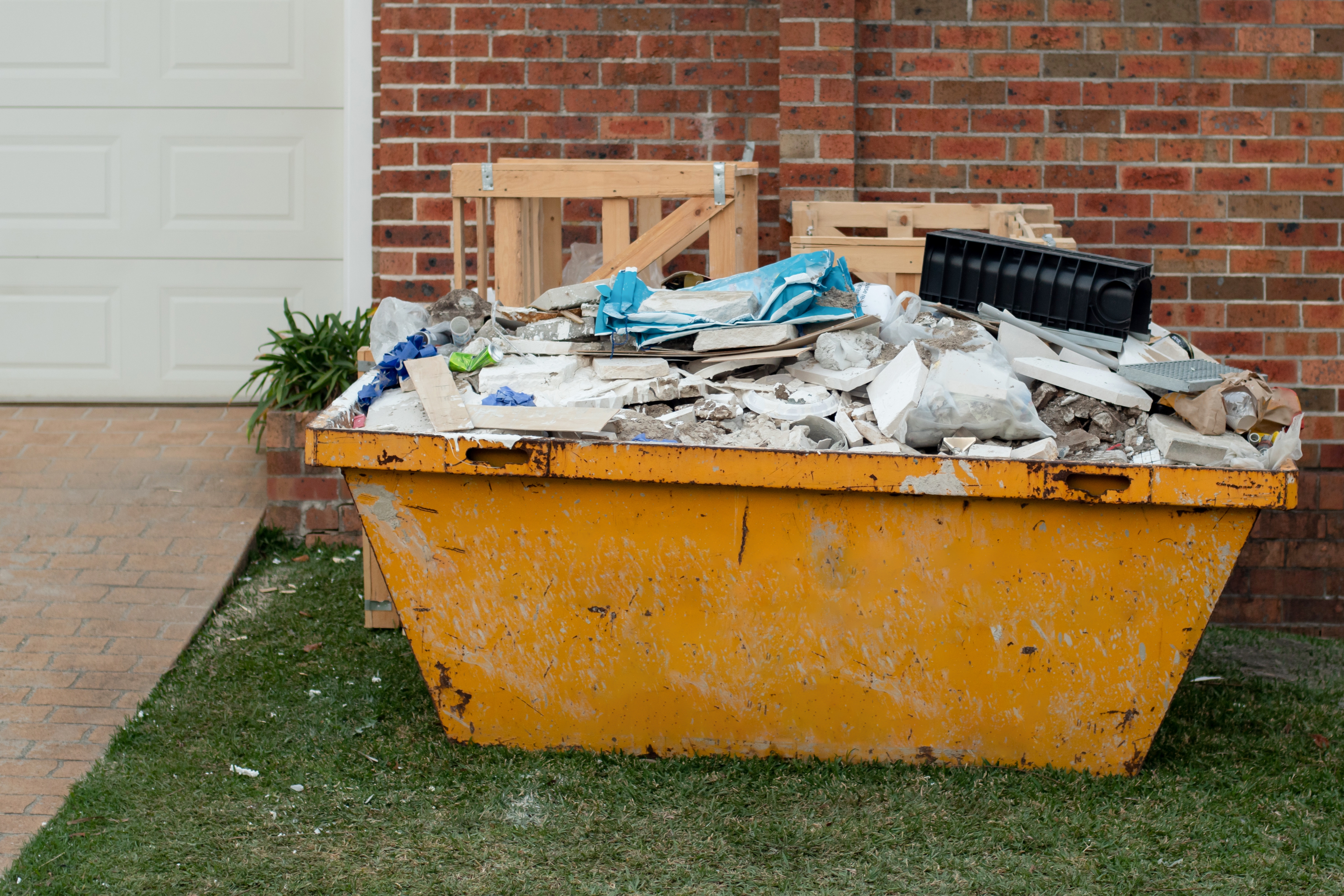 overfilled skip with construction waste